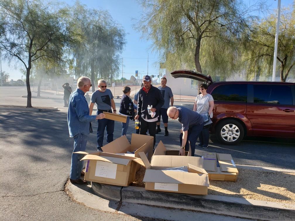 Serve Day 10-20-18 One man trying to decide on his size for his sweater